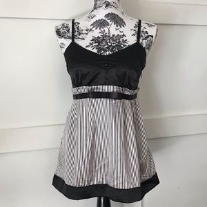 Tank top with buttons and peplum style and bow.